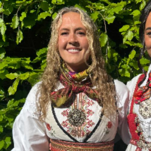Front of zip tote bag with white canvas, black canvas straps and handle, and black zipper pulls.