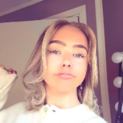 Front of zip tote bag with white canvas, black canvas straps and handle, and black zipper pulls.