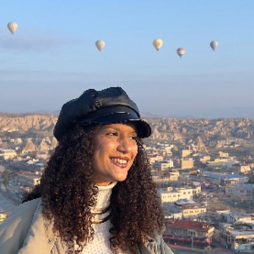 Front of zip tote bag with white canvas, black canvas straps and handle, and black zipper pulls.